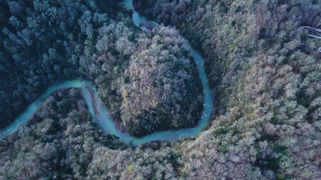 Top view on winding river and mountain. Clip. Aerial View on flying over the beautiful mountain...