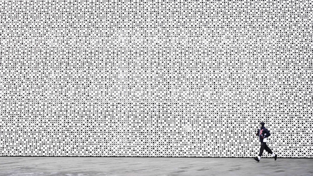 A man runs in front of the white patterned wall. Running man runner training doing outdoor city run sprinting along wall background. Urban healthy active lifestyle. Male athlete doing sprint hiit high intensity interval training. Banner panorama. Man in a leap. Free run. backgroundの写真素材