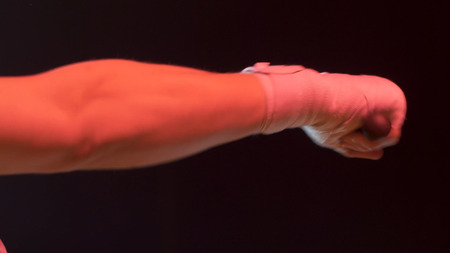 Boxer silhouette. Silhouette boxer man training at dark studio. Closeup of fighter workout. Man boxer exercising in dark. Mma fighter silhouette training at dark ring. Kickboxer silhouette training.の写真素材