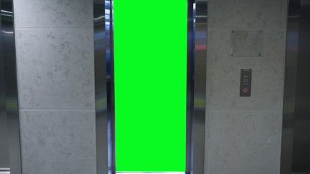 Opening doors in elevator with green screen. Elevator in office building.