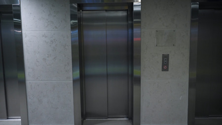 Modern elevator in a building. Elevator in office building. Closed elevator door on ground floor.の写真素材
