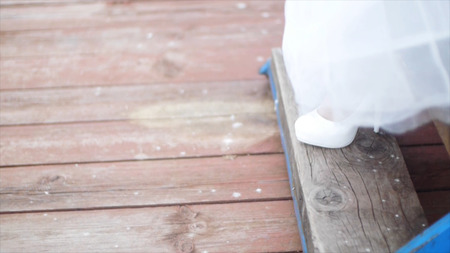 Close up of Beautiful Bride with Long Veil Down the Stairs. Clip. Woman in white shoes comes down...