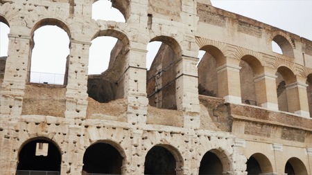 Colosseum or Flavian Amphitheatre in Rome. Stock. Arch of the famous Colosseum in Rome. The sun's shine through them.の写真素材