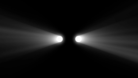 Silhouette of car with headlights on black background. Car headlights ray beam isolated. Light car.の写真素材