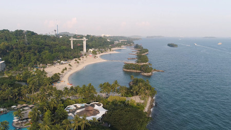 Beach with coconuts, sea travel destination. Shot. Top view of the beautiful hotel by the seaの写真素材