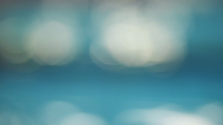 Light blue reflections bokeh background blur. Abstract water reflections to blur