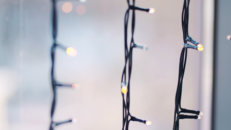 Star garland with bokeh lights at the background. Christmas window decoration garland, Scandinavian...