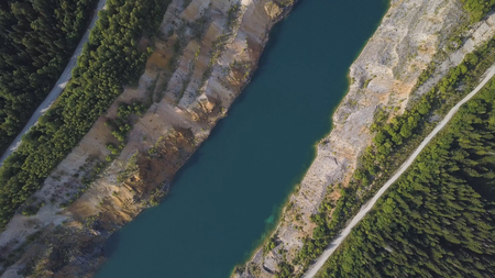 Morning quiet river with forest. Shot. Aerial View. Flying over the beautiful mountain River and forest. Aerial camera shot. Aerial panorama of the green forest and near mountain river. Landscape panorama.の写真素材