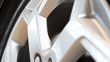Close up of a new, silver car rim. Stock. New rim and car alloy wheel.の写真素材