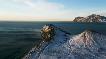 Aerial view on the edge of the mountain coast in Greenland. Aerial view on snow covered mountains in Greenland.の写真素材