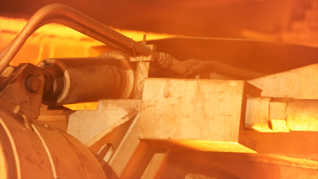 Close up for the detail of the working mechanism at the metal smelting plant. Stock footage. Machine...