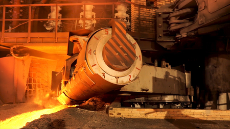 Close up for aluminum melting furnace in a foundry moving backwards, heavy metallurgy concept. Stock footage. Equipment of liquid and solid metal factory production.の写真素材