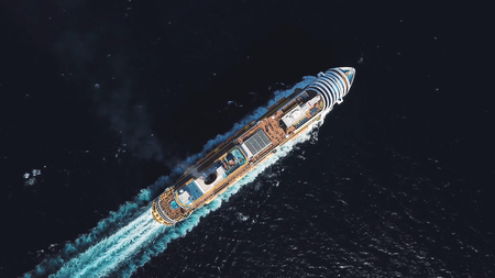 Aerial top view of luxury large cruise ship sailing full speed on open water, luxury vacation concept. Stock. Large Cruise ship sailing across The Mediterranean sea.の写真素材