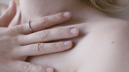 Female clavicles and neck. Action. Female clavicle. Perfect skin of a young woman close-upの写真素材