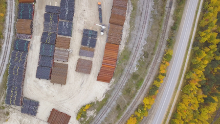 Top view of the industrial area located near the yellow forest, autumn nature. Clip. Aerial view of warehouses and the road near industrial zone.の写真素材