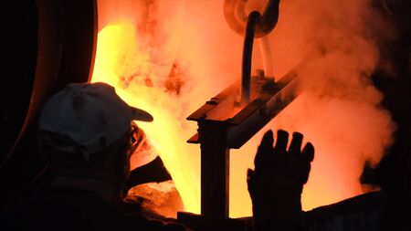 Hot steel pouring at steel plant. Stock footage. Flowing metal at the foundry. Pouring of liquid...