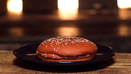 Burger bun on a plate. Stock footage. Appetizing bun for cooking a Burger. Delicious foodの写真素材