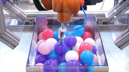 Robot hand machine picking up ball. Media. Use smart robot in manufacturing industry. Robot engineering conceptの写真素材