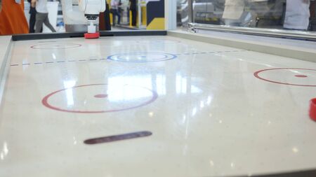 Robot plays with a man in table hockey. Media. High technologies of robots developmentの写真素材