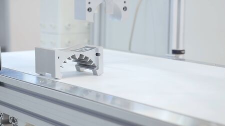 Robotic arm lifts detail. Media. The robotic arm use in detail parts production line. The...