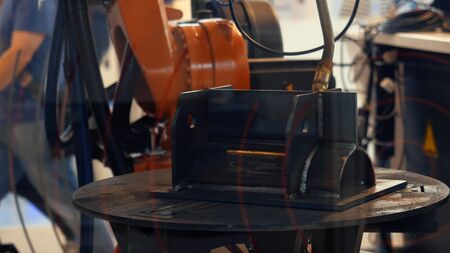 Close-up view of automatic robotic arm making metal welding operations. Different working robots collection presented on the robotics forum exhibitionの写真素材