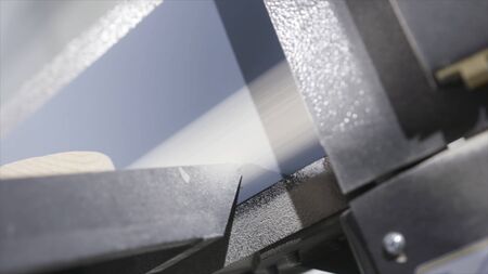 Wood surface grinding machine. Action. Close-up of moving strip of industrial grinding machine. Belt sander in industrial woodworking enterpriseの写真素材