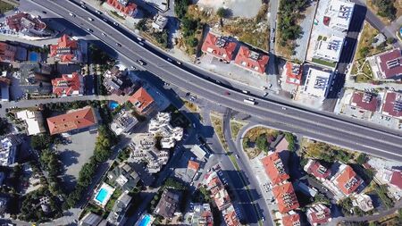 Top view of resort town on mountain coast near blue sea. Clip. Beautiful panorama of city located on...