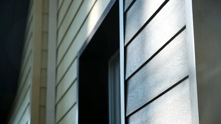 Decoration of houses with siding. Stock footage. Wooden facing of facade of house. Beautiful facade decoration of house made under wooden texture.の写真素材