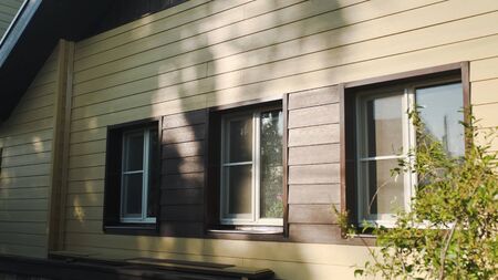 Decoration of houses with siding. Stock footage. Wooden facing of facade of house. Beautiful facade...