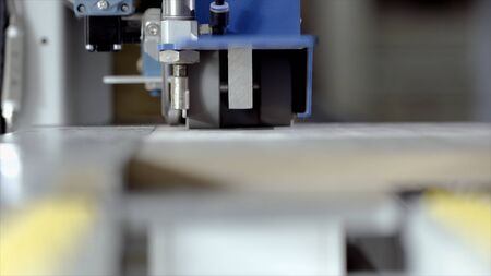 Close-up of machine for rolling parts. Action. Automated machine with rotating gears for rolling...