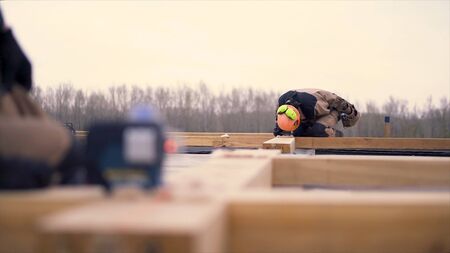Close up of laser measurement level for construction works standing on a wooden bar at the...