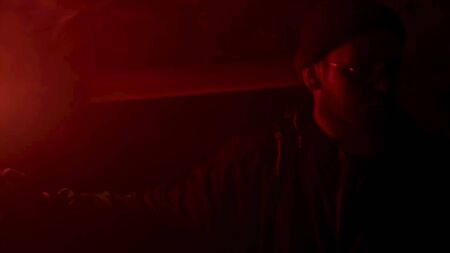 Close up of a man face with worried expression under the red light, emergency situation concept....