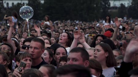 Australia - Sydney, 08.25.2019: crowd at music concert, audience raising .ands up and having fun. Action. Many people, fans enjoying music concert at the city square.のeditorial素材