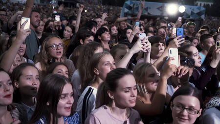 Greece - Thessaloniki, 10.15.2019: people taking photographs with touch smart phone during a music...