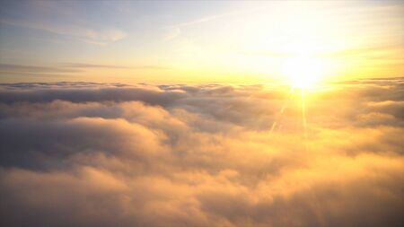 Amazing view from plane on the sky, sunrise, and clouds. Footage. Haven lit by golden sun and soft white clouds on blue sky background.の写真素材