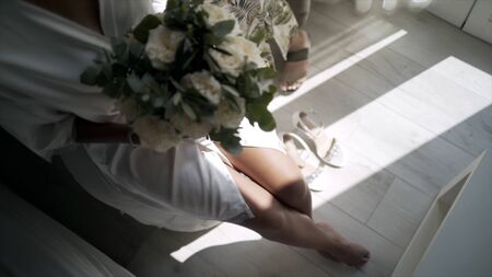 Stylists prepare elegant bride for wedding ceremony. Action. Beautiful bride is preparing for wedding ceremony. Exciting and happy moments of preparing bride for weddingの写真素材