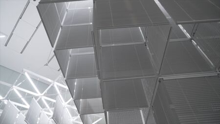 White room with bright light and suspended installations. Action. White room with unusual suspended installations and mirrors illuminated by bright lighting in Museum of modern artの写真素材