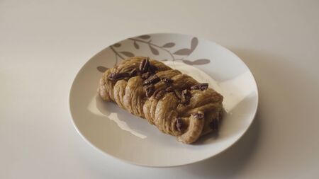 Several plates with delicious pastry products placed in one row on wooden table. Close up of yummy bread products on white table background.の写真素材