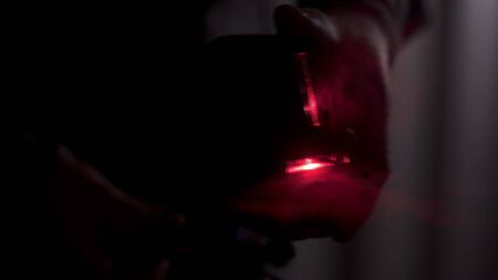 Red laser light lines for level measure in dark room, construction tools and equipment concept....