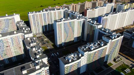 Top view of multi-colored facade of multi-storey residential building. Motion. Beautiful modern...