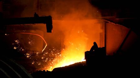 Iron and steel metallurgical plant, metallurgical production. Metal Melting process with many flying bright sparkles.の写真素材