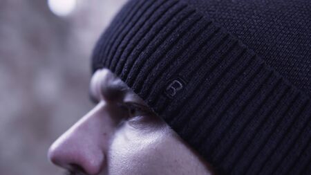 Close-up of a man's face in a black hat. Footage. Extreme close up of a man's face.の写真素材