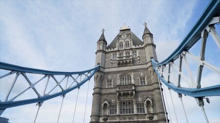London, Britain-September, 2019: Bottom view of tower of tower bridge on background of blue sky. Action. Architectural old bridge tower in Europeのeditorial素材