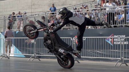 Yekaterinburg, Russia-August, 2019: Professional motorcyclist performs tricks on motorcycle. Action. Rider shows beautiful thrilling stunts at freestyle showのeditorial素材