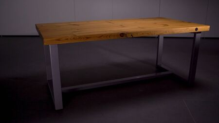 Stylish wooden table in empty room. Stock footage. Beautiful wooden table with iron legs stands in...