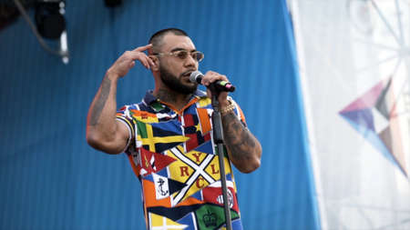 Yekaterinburg, Russia-August, 2019: Dark-skinned singer on stage. Action. Famous foreign singer reads rap or performs pop music on stage of summer festival in cityのeditorial素材