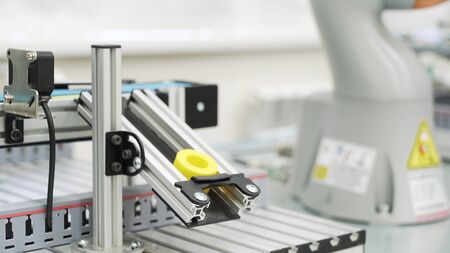 Close up of yellow object created by 3D printer in modern workshop. Technological background of robotic mechanism making a detail, science concept.の写真素材