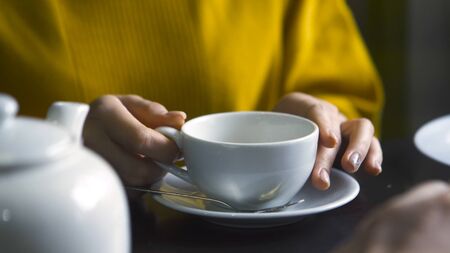 Close-up of man and woman talking over tea. Stock footage. Man gestures with hands while talking to...