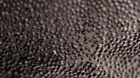 Black peppercorn background, grains lying on glass surface. Stock footage. Close up of black pepper...