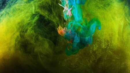 Beautiful splash of multicolored ink mixing in water. Stock footage. Streams and explosions of beautiful colored ink in water, like surging emotions and feelings.の写真素材